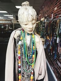 Close-up of mannequin with necklaces in store