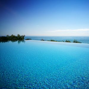 Infinity pool and sea against blue sky