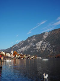 Scenic view of lake and mountains against blue sky