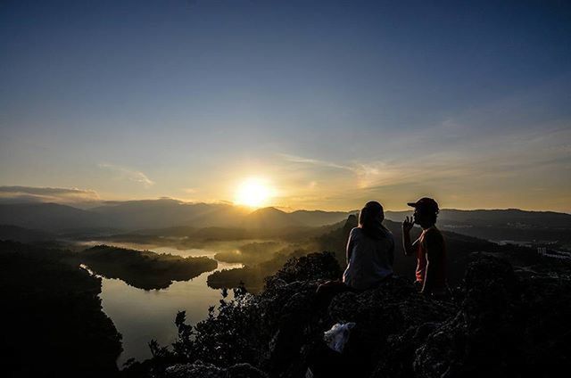 sunset, scenics, tranquil scene, leisure activity, beauty in nature, lifestyles, tranquility, men, sky, nature, sun, rock - object, person, vacations, landscape, togetherness, mountain, standing