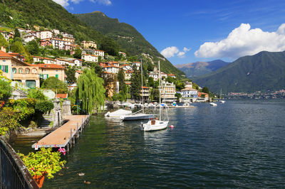 Boats in river against built structures