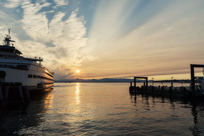 Boat on sea against sky during sunset