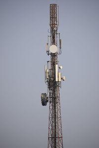 Low angle view of communications tower against clear sky