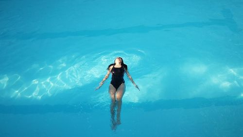 Young woman swimming in pool