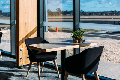 Empty chairs and table in airport