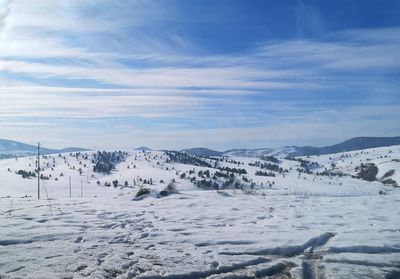 Scenic view of snow covered landscape against sky