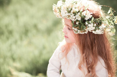 Close-up of girl wearing wreath at park