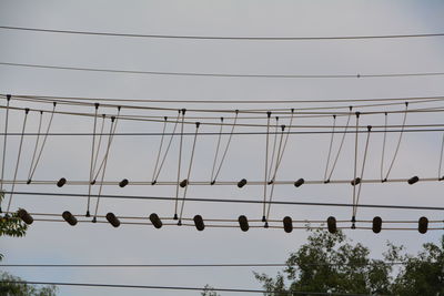 Low angle view of cables against sky during sunset