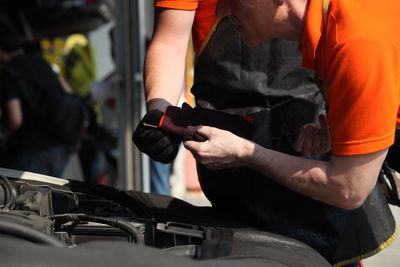 Midsection of man working at bus