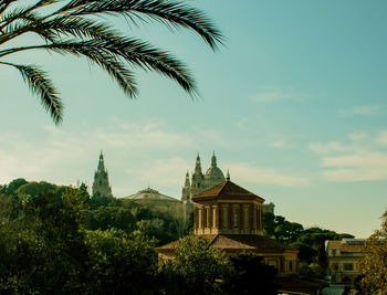 View of building and trees against sky