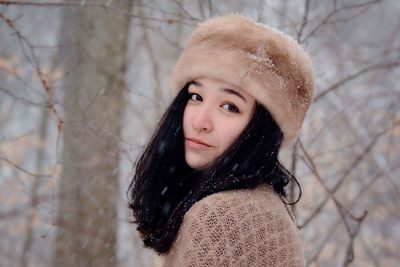 Portrait of young woman wearing knit hat in winter