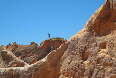 Low angle view of mountain against blue sky