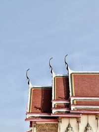 Low angle view of building roof against sky