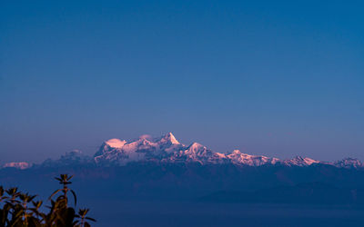 Scenic view of mountains against clear blue sky