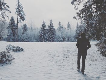 Full length of man standing on snow covered landscape