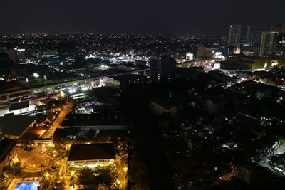 High angle view of illuminated buildings in city at night