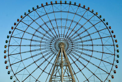 Low angle view of ferris wheel against sky