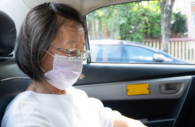 Close-up of woman sitting in car