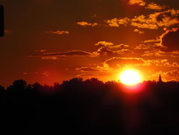 Silhouette trees against sky during sunset