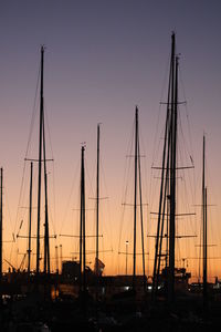 Silhouette sailboats against sky during sunset
