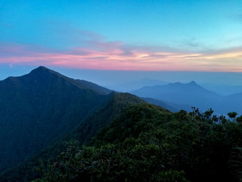 Scenic view of mountains yong belar against sky at sunset