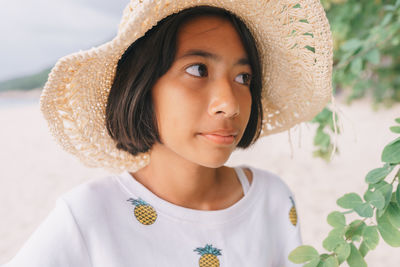 Close-up portrait of a girl wearing hat