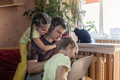 Mother and girl sitting at home