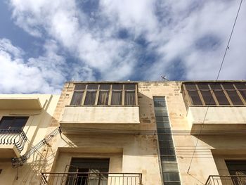 Exterior of historic building against cloudy sky