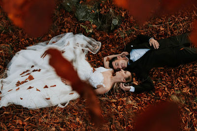 High angle view of young woman lying down on land