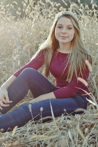 Portrait of woman sitting on field