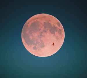 Low angle view of moon against clear sky at night
