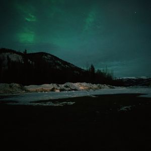 Scenic view of frozen lake against sky at night