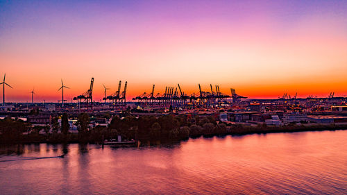 Scenic view of harbor against sky during sunset