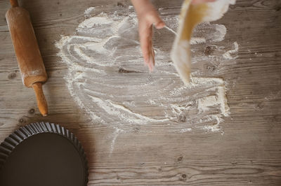 Cropped image of hand preparing food on table