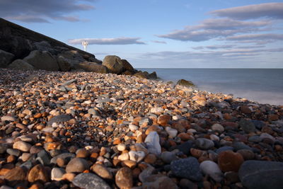 Rocks on beach against sky