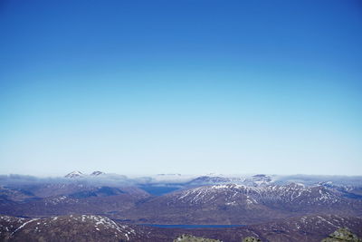Scenic view of mountains against clear blue sky