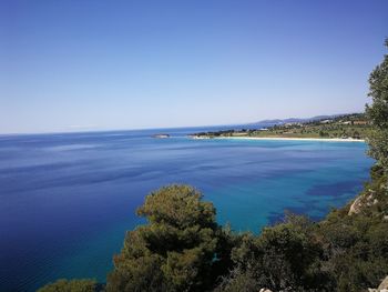 Scenic view of sea against clear blue sky