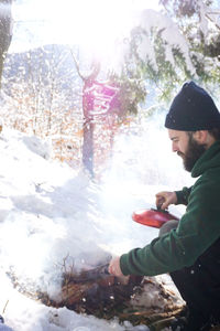 Side view of young man in snow