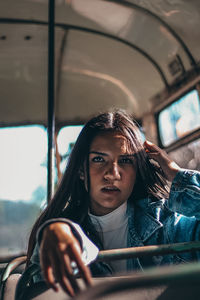 Portrait of young woman sitting in car