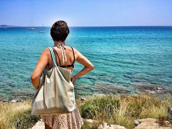 Rear view of woman looking at seascape