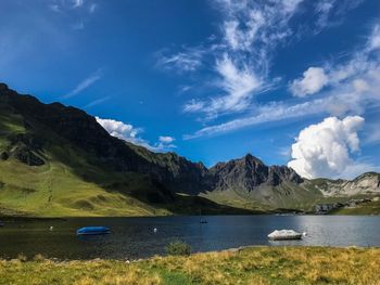 Scenic view of lake and mountains against sky