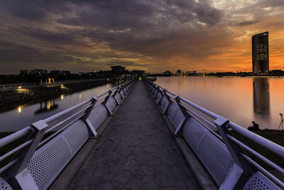 Scenic view of illuminated city against sky during sunset