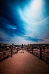 Man standing on land against sky