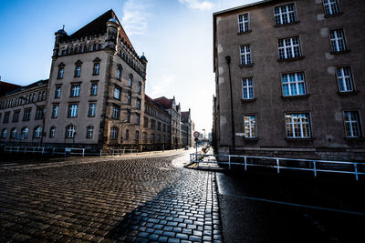 Man walking on street amidst buildings in city