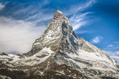 Low angle view of snowcapped mountain against sky