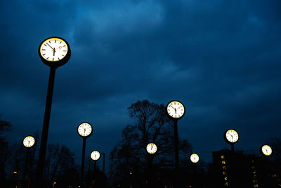 Low angle view of illuminated street light against sky