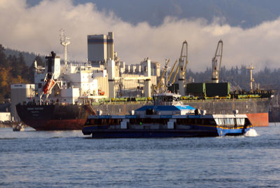 Commercial dock by sea against sky