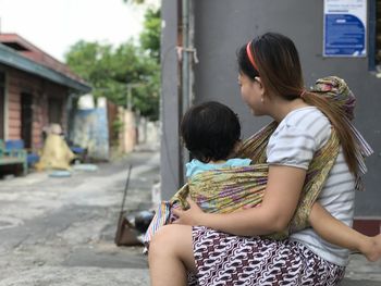 Side view of mother and daughter outdoors