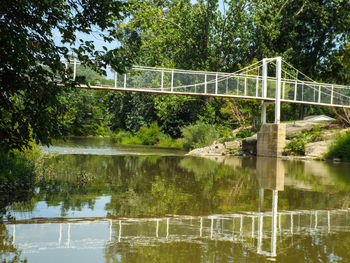 Bridge over lake against trees