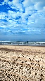 Scenic view of beach against blue sky